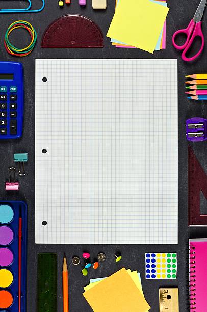 istock Graphing paper with school supplies frame on chalkboard 546447632