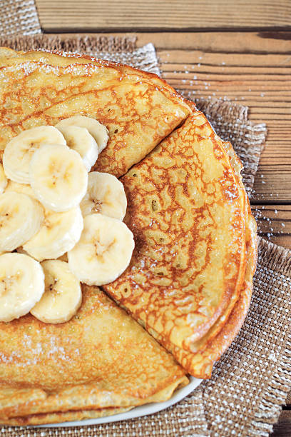 istock Pancakes, dusted with powdered sugar, with a banana. 546449052