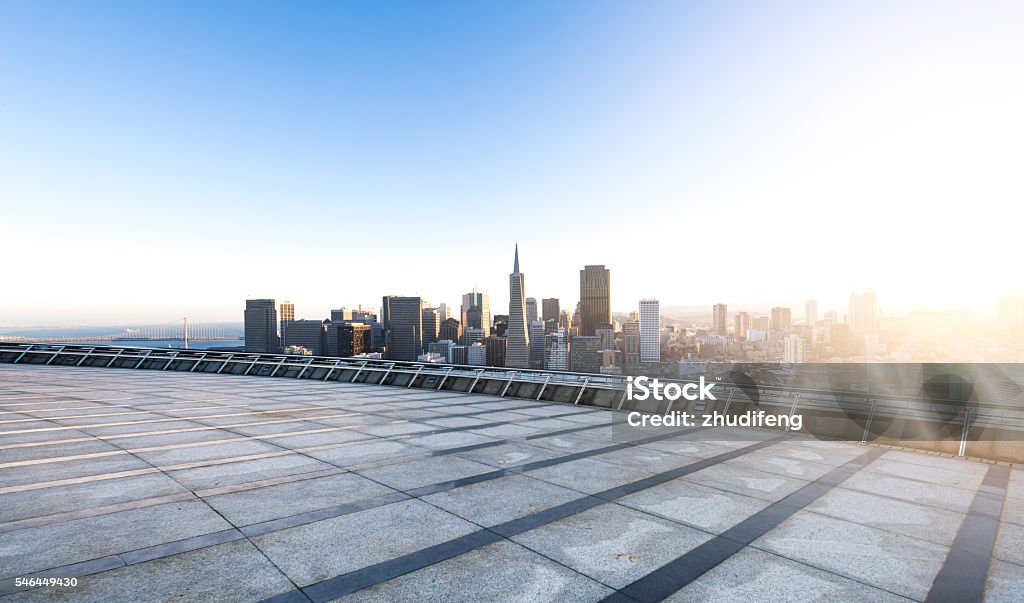 empty street with cityscape and skyline of san francisco sunrise cityscape and skyline of san francisco at sunrise on view from empty street San Francisco - California Stock Photo