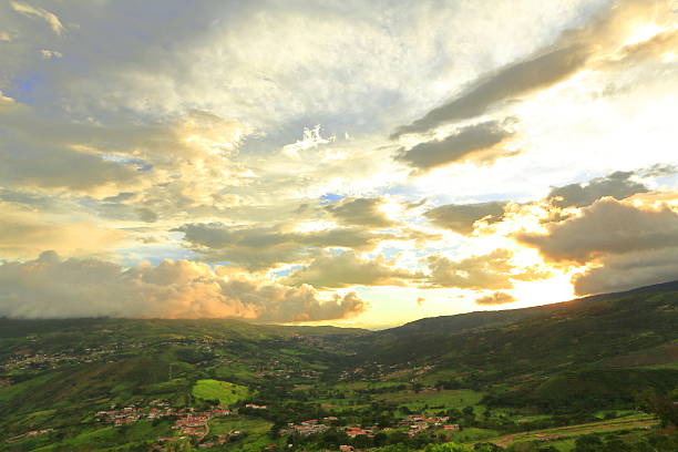 Strong sunrays colors on the clouds that pass over the mountains valley during sunset hour. This is looking to the two Capacho cities in San Crustobal, Tachira State, Venezuela.