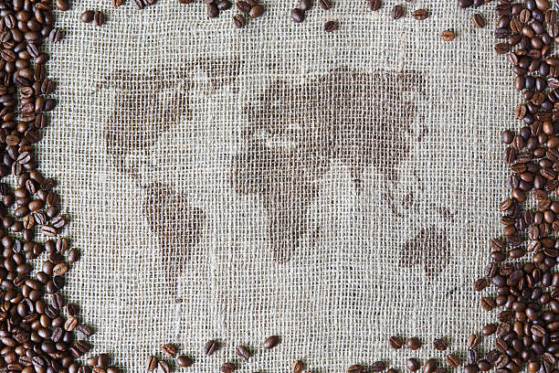 istock Burlap texture with coffee beans border and world map 546450898