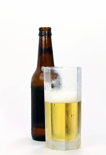 istock Frosted glass of beer with bottle in background 546454002