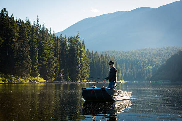 Spin fishing Spin fishing from a boat on a stunning mountain lake pemberton bc stock pictures, royalty-free photos & images