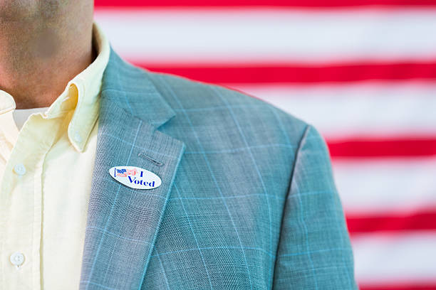 istock Man wearing I voted sticker on jacket 546456668