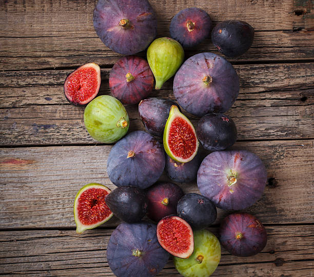 Fresh figs in different grade Fresh figs in different grade, vintage wooden Board.selective focus fig photos stock pictures, royalty-free photos & images
