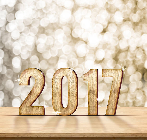 istock 2017 year wood on plain wood table top with gold 546457058