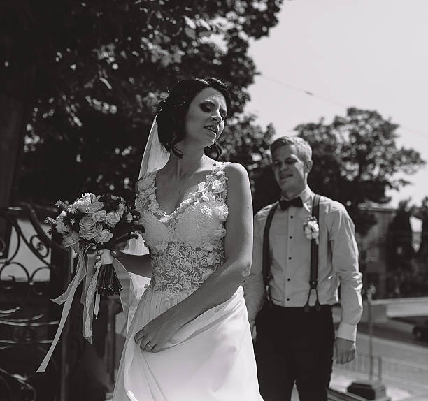 istock bride and groom posing on the streets 546457710
