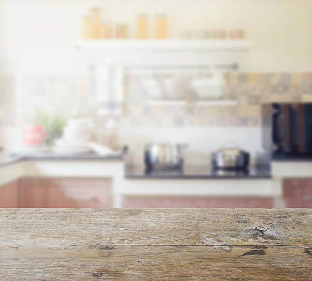 istock wooden table top with blur of modern kitchen interior 546457882