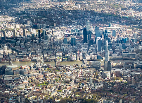 An aerial view, taken from an aircraft flying over the south of London, looking north towards St Paul's Cathedral (at the left of the image), and across to the cluster of modern towers in the City of London, the capital's main business and finance district.