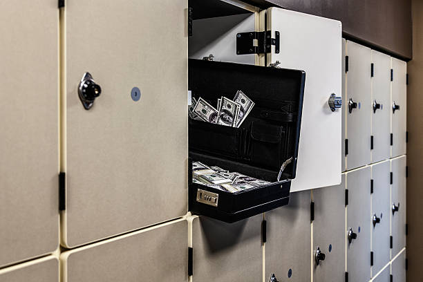istock Office Locker Open Briefcase Full of Dark Money 546460158
