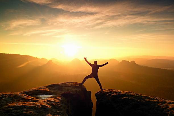 istock Hiker in black triumph between two rocky peaks 546461058