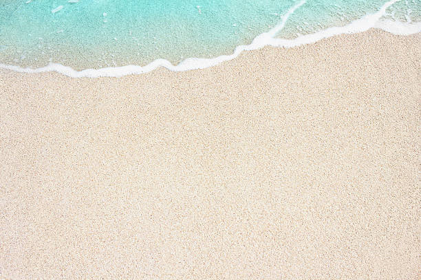 soft blue ocean wave on sandy beach - southern usa sand textured photography imagens e fotografias de stock