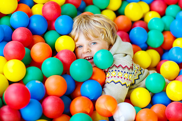 istock child playing at colorful plastic balls playground 546462592