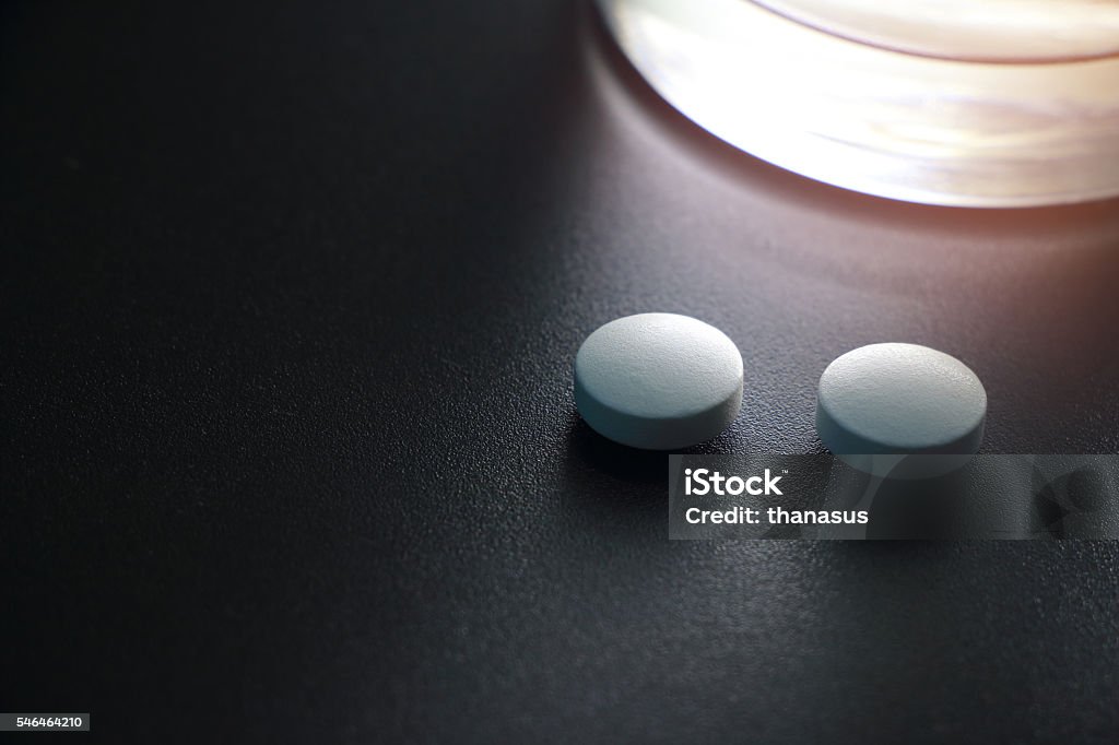 white pills on black background, insomnia Antibiotic Stock Photo