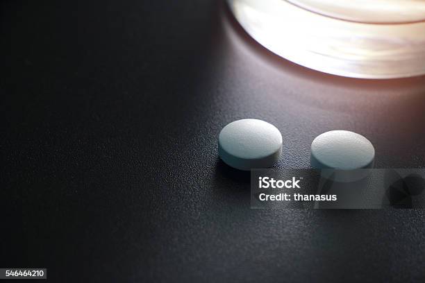 White Pills On Black Background Insomnia Stock Photo - Download Image Now - Antibiotic, Backgrounds, Black Background