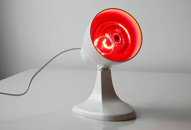 Medicinal red-light-lamp standing on a table