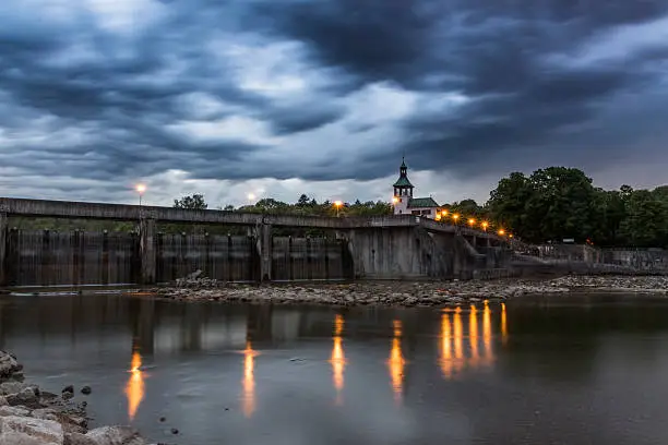 Dramatic thunderstorm sky with cloud elevation over the weir, called Hochablass, on the river Lech in Augsburg