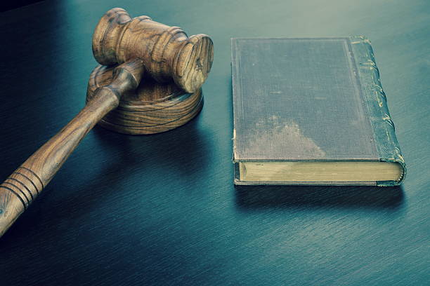 istock Judges Hammer or Gavel With Old Book On Dark Background 546465704