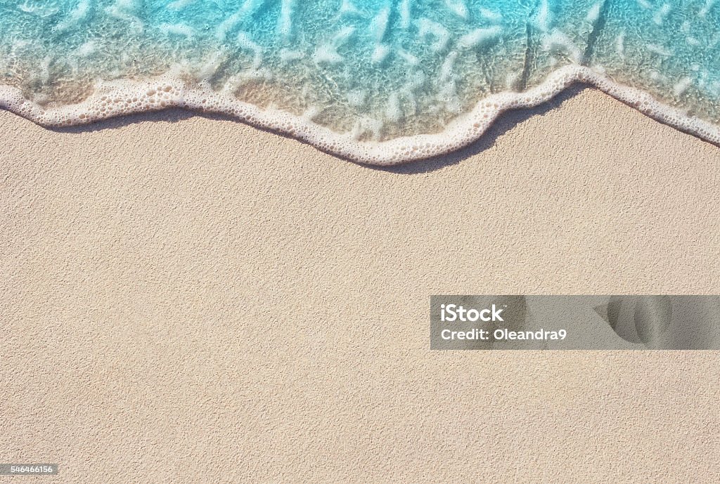 Soft wave of ocean on sandy beach Soft wave of blue ocean on sandy beach, background. Selective focus. Beach Stock Photo