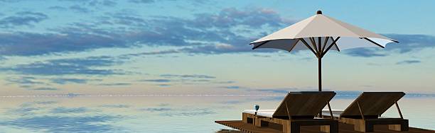 istock Deck Chairs and umbrella in sunset on the beach 546466456