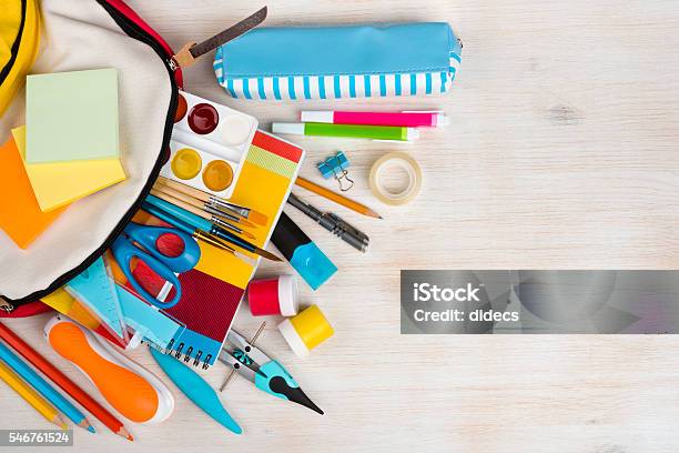 Various Stationery School And Office Supplies Over Wooden Texture Background Stock Photo - Download Image Now