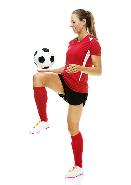 istock Smiling female soccer player juggling 546762110