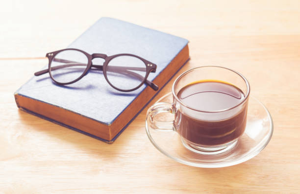 Coffee, book and eye glasses stock photo