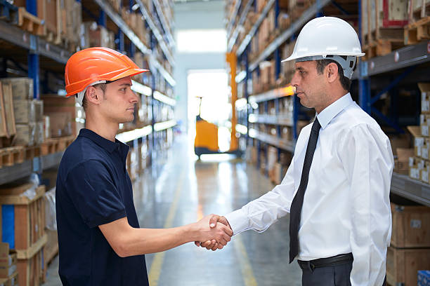 istock Manager and employee handshake in warehouse 546763820