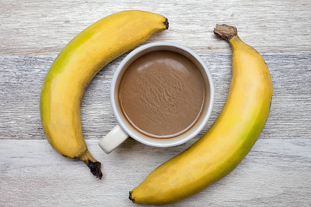 istock Coffee and banana on wooden background 546764000