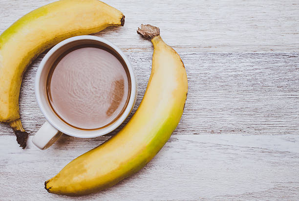 istock Coffee and banana on wooden background 546764252