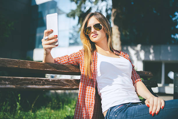 istock beautiful young woman using smartphone 546765274