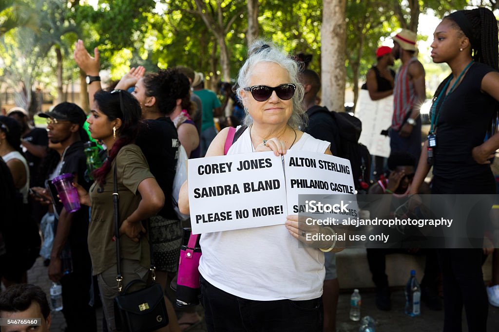 Black Lives Matter in Fort Lauderdale Fort Lauderdale, United States - July 9, 2016: Woman holding up a sign of slain african american people during the black lives matter rally. African Ethnicity Stock Photo