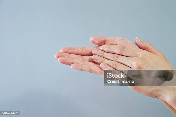 Rubbing Hands Stock Photo - Download Image Now - Rubbing, Applying, Beauty