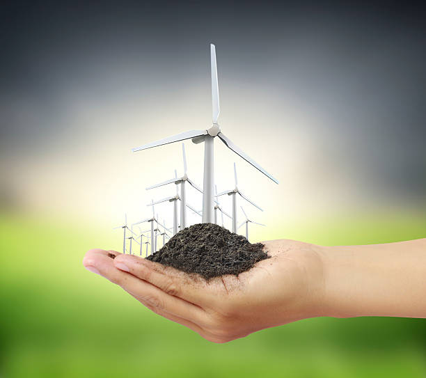 istock Eco power, wind turbines in  hand 546768452