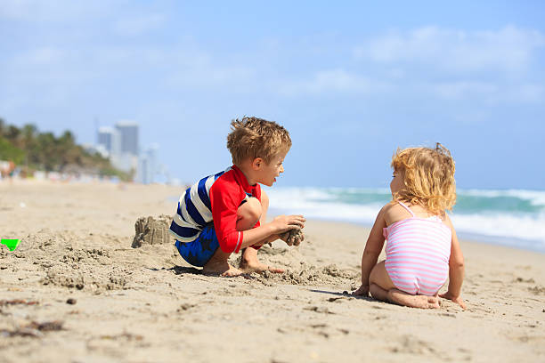 istock kids play with sand on summer beach 546769774