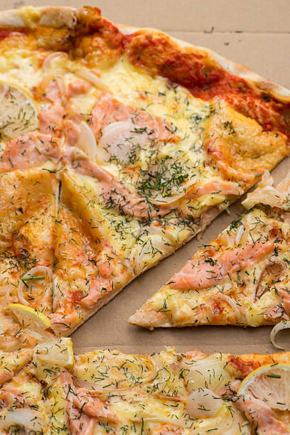 istock Delicious salmon pizza in a cardboard box 546770840
