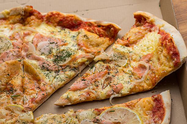 istock Delicious salmon pizza in a cardboard box 546771016