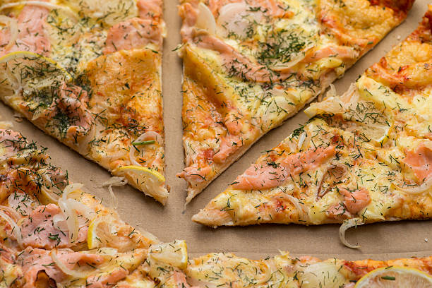 istock Delicious salmon pizza in a cardboard box 546771132