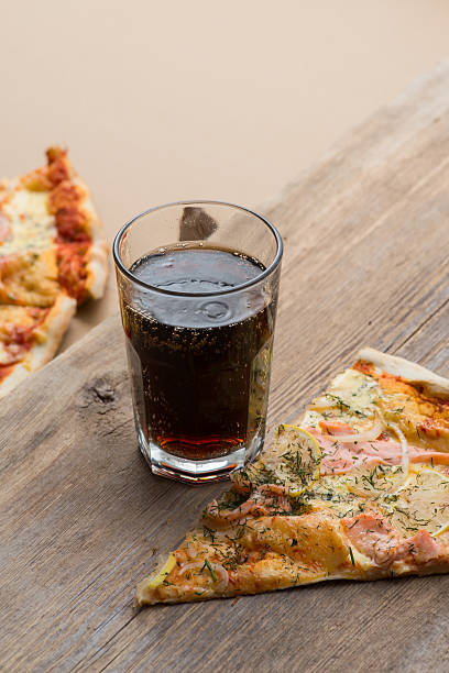 istock Delicious salmon pizza and coke on a wooden table 546771784