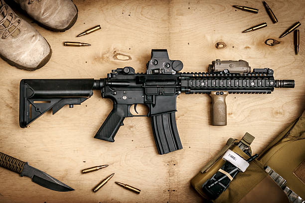 istock Assault rifle on a wooden table 546773524