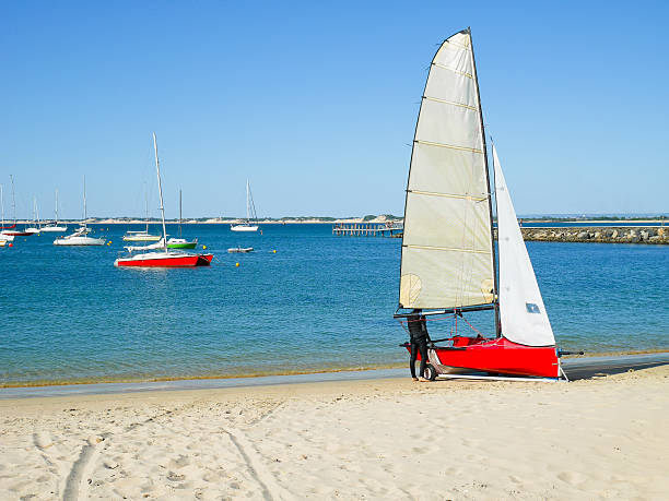 istock Young man standing next to sailboat 546774268