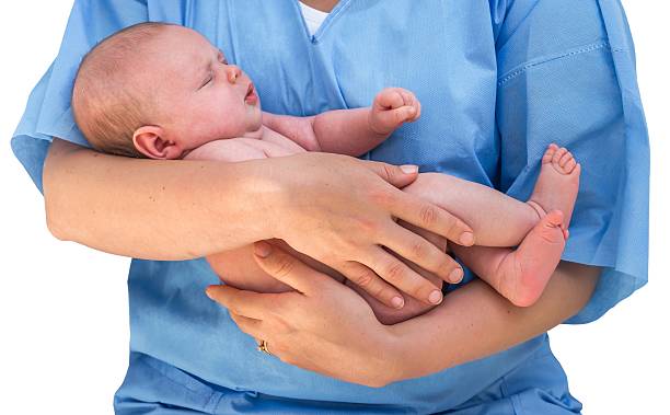Doctor holding a beautiful newborn baby Doctor holding a beautiful newborn baby isolated od white background midwife photos stock pictures, royalty-free photos & images