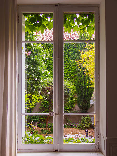istock beautiful old window towards courtyard with flowers 546774346