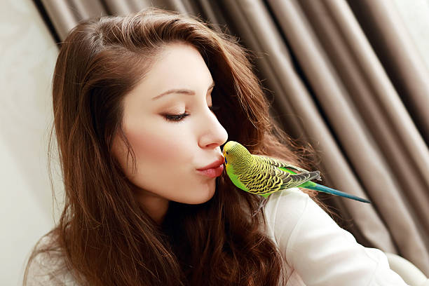istock woman with green parrot 546775366