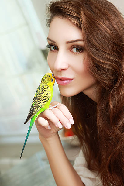 istock woman with green parrot 546775496