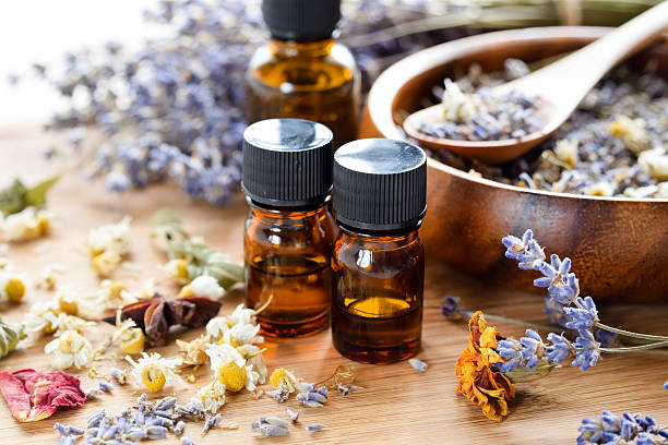 dried herbs and essential oils dried herbs with essential oils using lavender and chamomile aromatherapy oil stock pictures, royalty-free photos & images