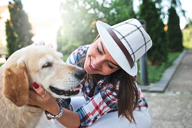 istock Woman embracing her dog in  park 546776624