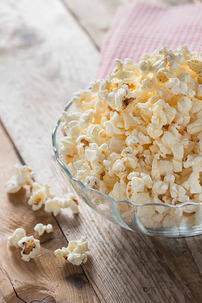 istock Bowl of popcorn on wood table. Selective focus. 546777210