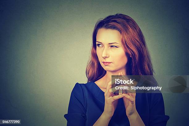 Sneaky Sly Scheming Young Woman Plotting Something Stock Photo - Download Image Now