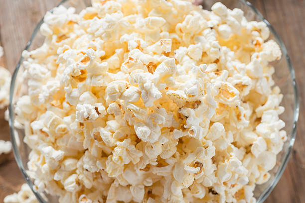 istock Bowl of popcorn on wood table. Top view. 546777408